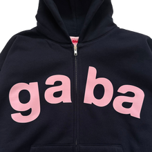 Load image into Gallery viewer, A close-up of a navy zip-up hoodie featuring the word 'gaba' printed in large pink lowercase letters across the chest, with a front kangaroo pocket and hood.
